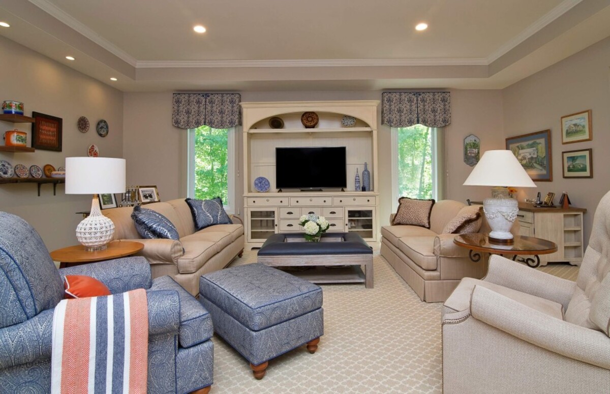The details in this room include a blue and cream color palette, contrast welt on the seating and pattern on the carpeted floor.