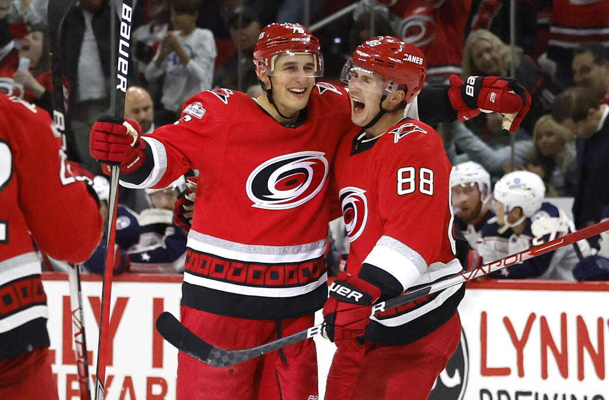 Carolina’s Martin Necas (88) celebrates with Brady Skjei (76) after Skjei scored during the second period of the Carolina Hurricanes game against the Columbus Blue Jackets at PNC Arena in Raleigh, N.C., Wednesday, Oct. 12, 2022.