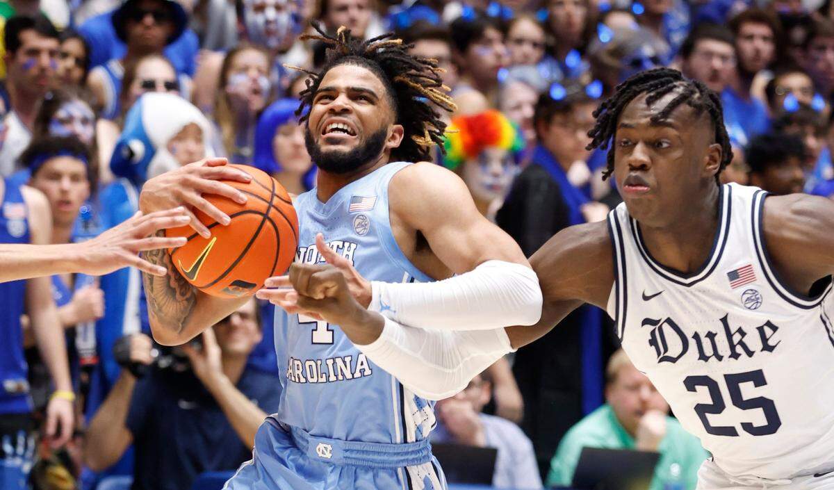 North Carolina’s R.J. Davis (4) drives past Duke’s Mark Mitchell (25) during the first half of Duke’s game against UNC at Cameron Indoor Stadium in Durham, N.C., Saturday, Feb. 4, 2023.