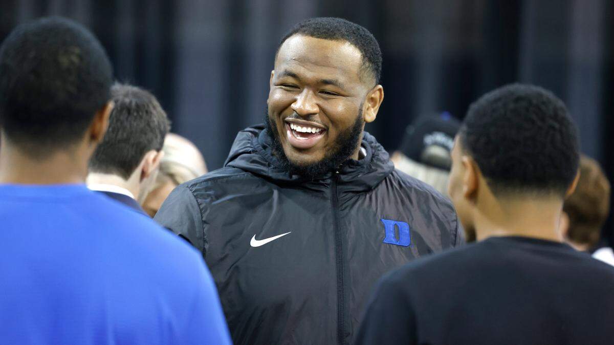 Duke’s DeWayne Carter laughs with others after a press conference where was Manny Diaz introduced as Duke football’s new head coach Saturday, Dec. 9, 2023.