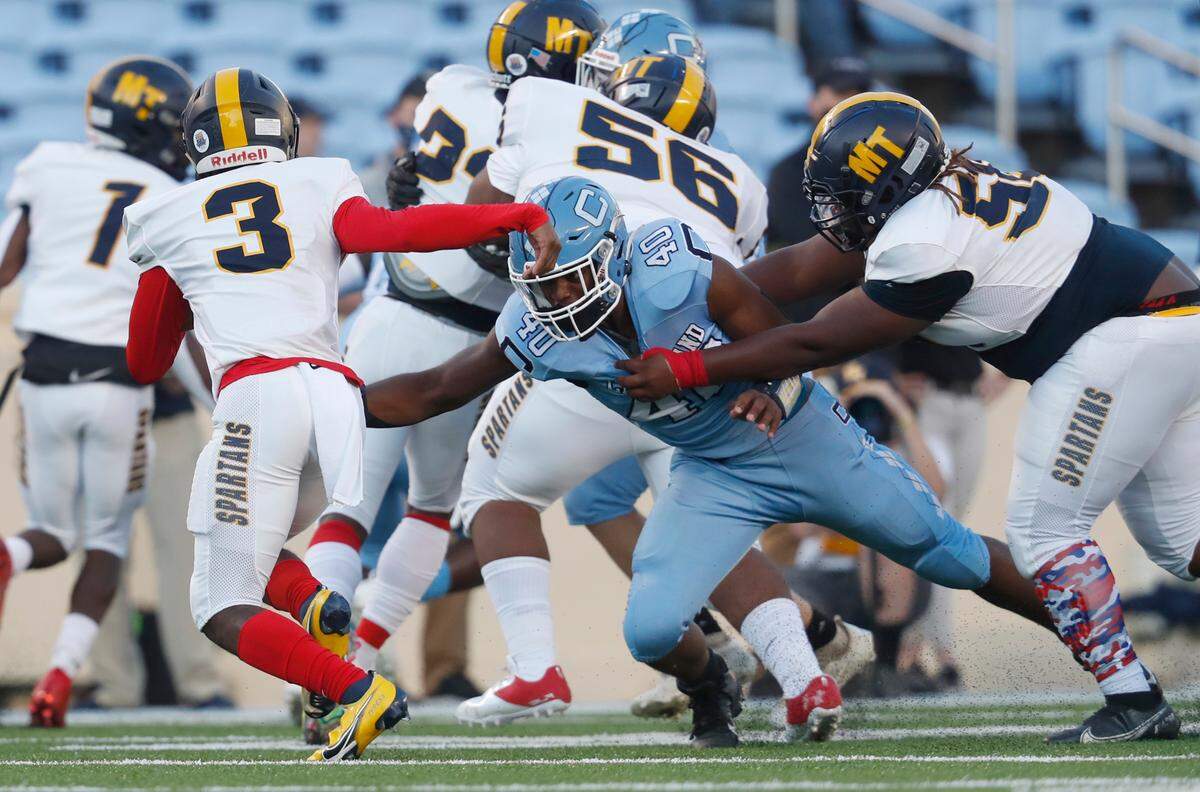 Cleveland’s Trey Robinson (40) gets around Mount Tabor’s Austin Pittman (50) as he looks to tackle Tyress Mcintyre (3) in the 3AA state high school championship game at Kenan Stadium in Chapel Hill, N.C., Thursday, May 6, 2021.