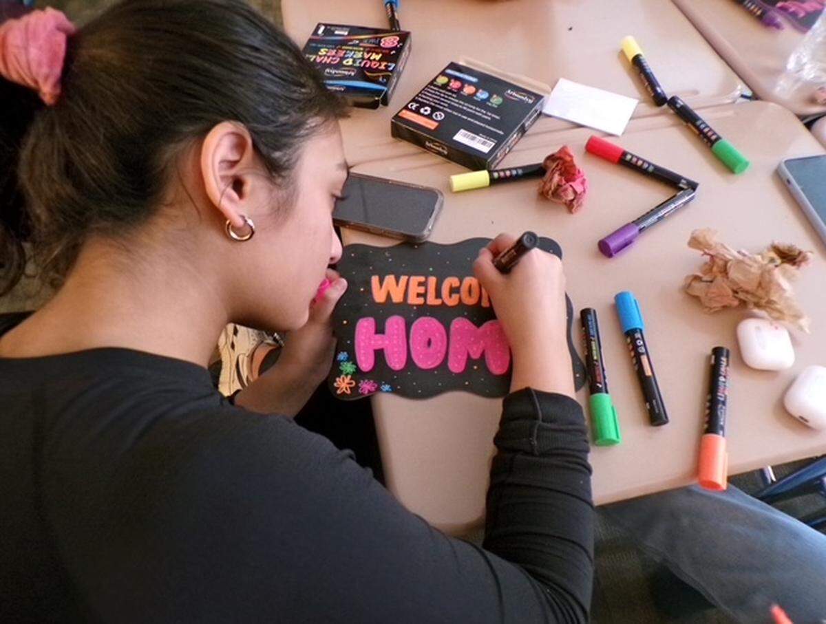 Enloe High School student Trishana Ghosh makes a welcome sign for future residents of CASA’s King’s Ridge community on Oct. 22, 2024 in Raleigh. N.C. The 2024 Enloe Charity Ball is raising money to support CASA’s efforts to reduce homelessness in Wake County.