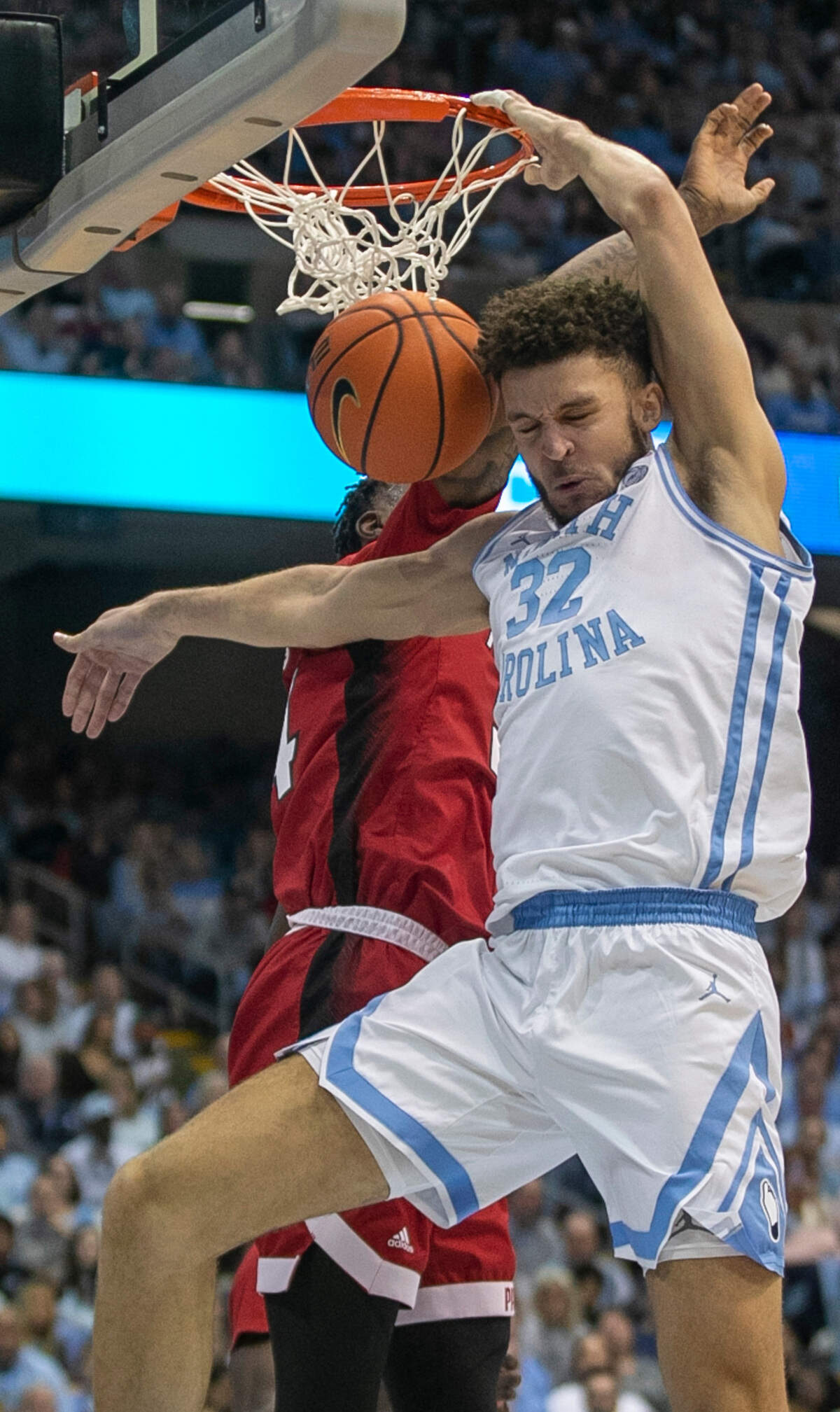 North Carolina’s Pete Nance (32) dunks on N.C. State’s Ernest Ross (24) during the second half on Saturday, January 21, 2023 at the Smith Center in Chapel Hill, N.C.