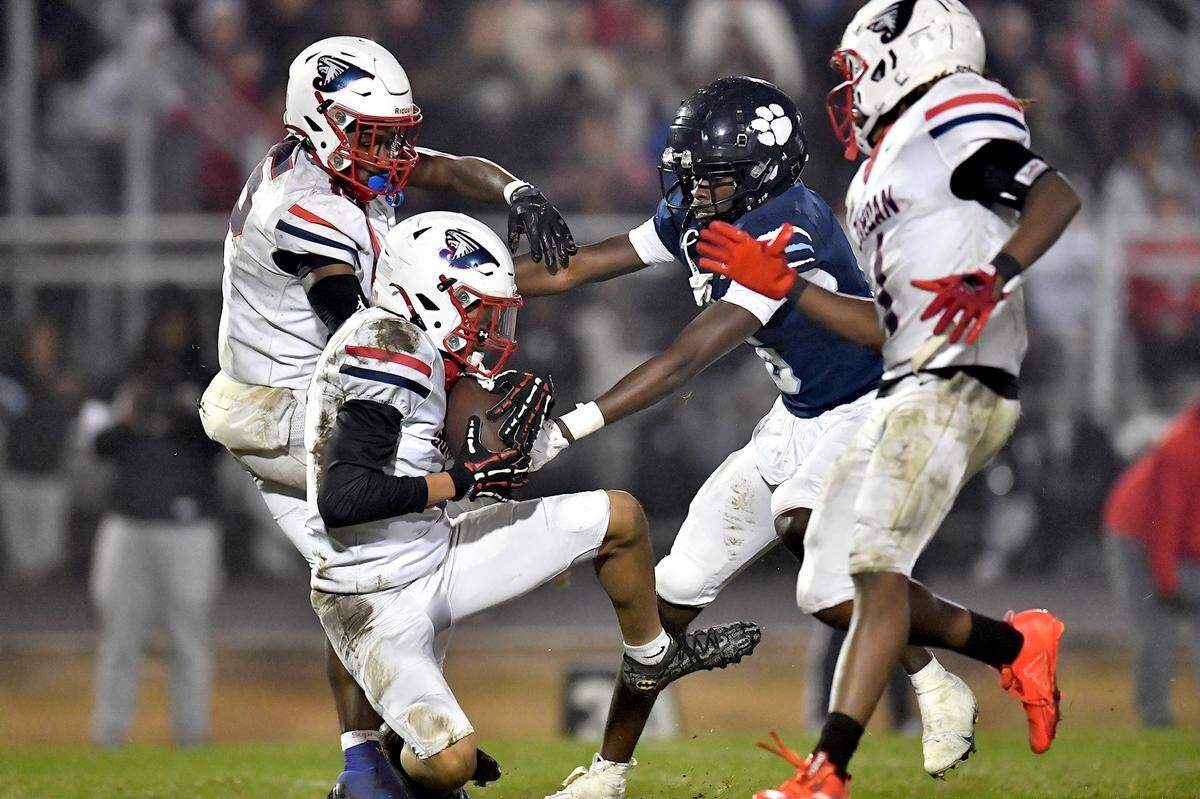 Jordan defensive back Ezkiel Stokes (4) makes the interception against Millbrook during the second half. The Millbrook Wildcats and the Jordan Falcons met in the third round of the NCHSAA 8A football playoffs in Raleigh, N.C. on November 21, 2025. 