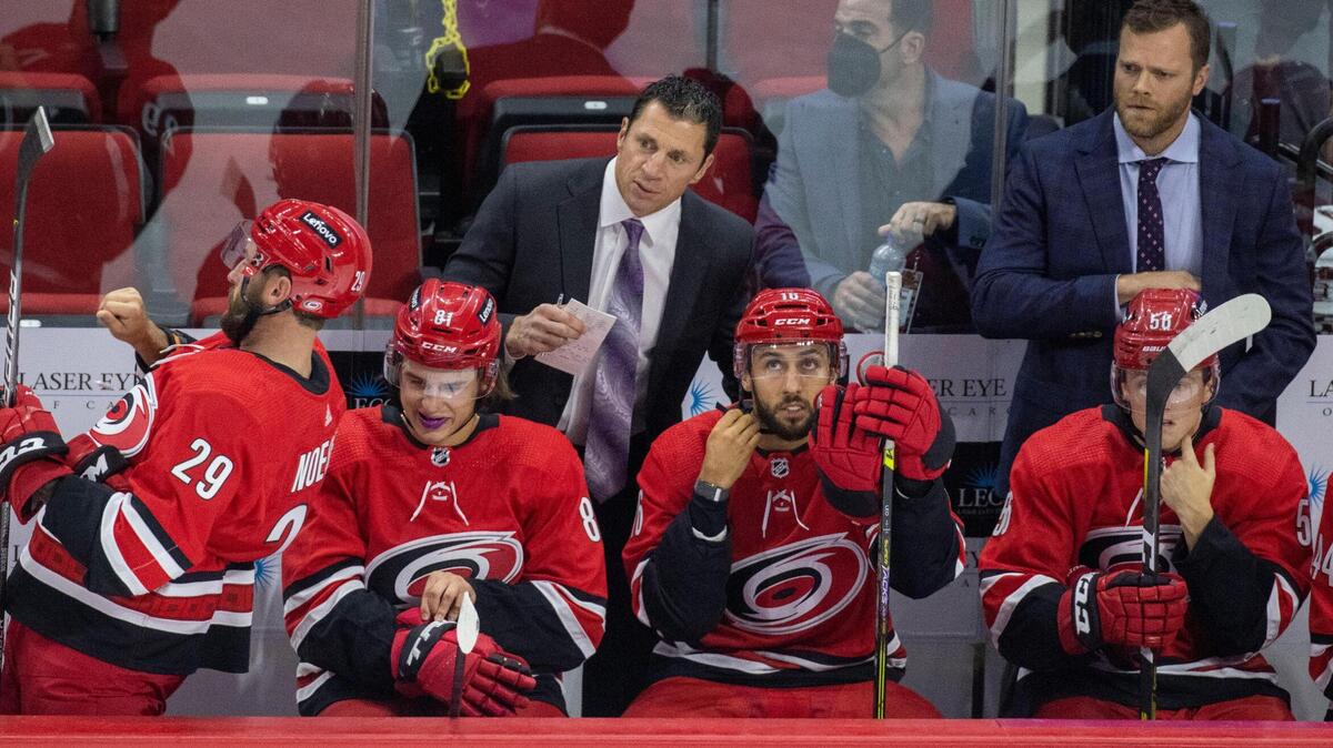 Carolina Hurricanes’ coach Rod Brind’Amour, left,and assistant coach Tim Gleason work behind the bench in NHL exhibition game against Tampa Bay on Tuesday, September 28, 2021 at PNC Arena in Raleigh, N.C.