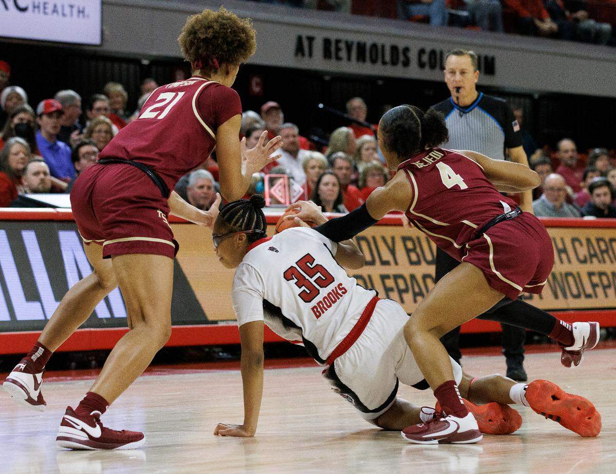 Florida State’s Makayla Timpson and Sara Bejedi force a turnover by N.C. State’s Zoe Brooks during the second half of the Wolfpack’s 88-80 win on Thursday, Jan. 4, 2023, at Reynolds Coliseum in Raleigh, N.C.