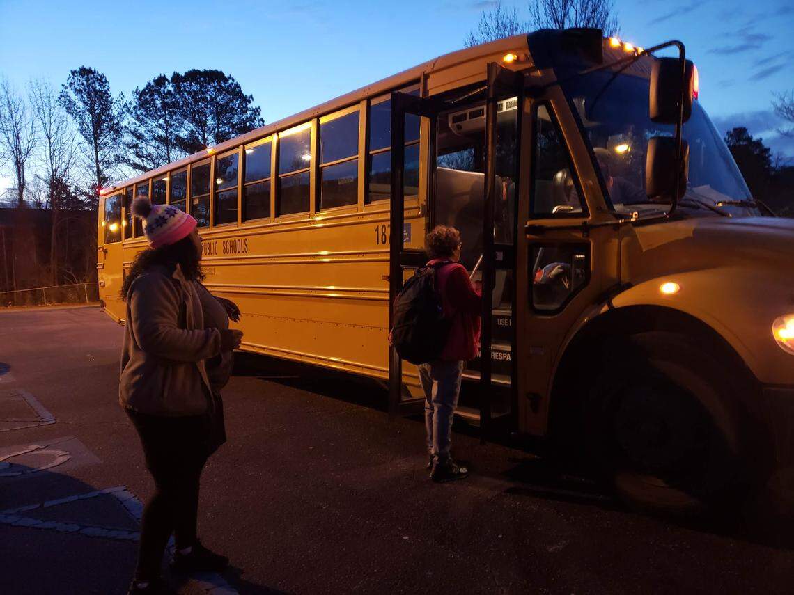 Samanther Crowder says goodbye to Cody Hayes, 9, on a Durham Public Schools bus that stopped at Millennium Hotel to take McDougald Terrace residents to school on Monday,  Jan. 27, 2020. 