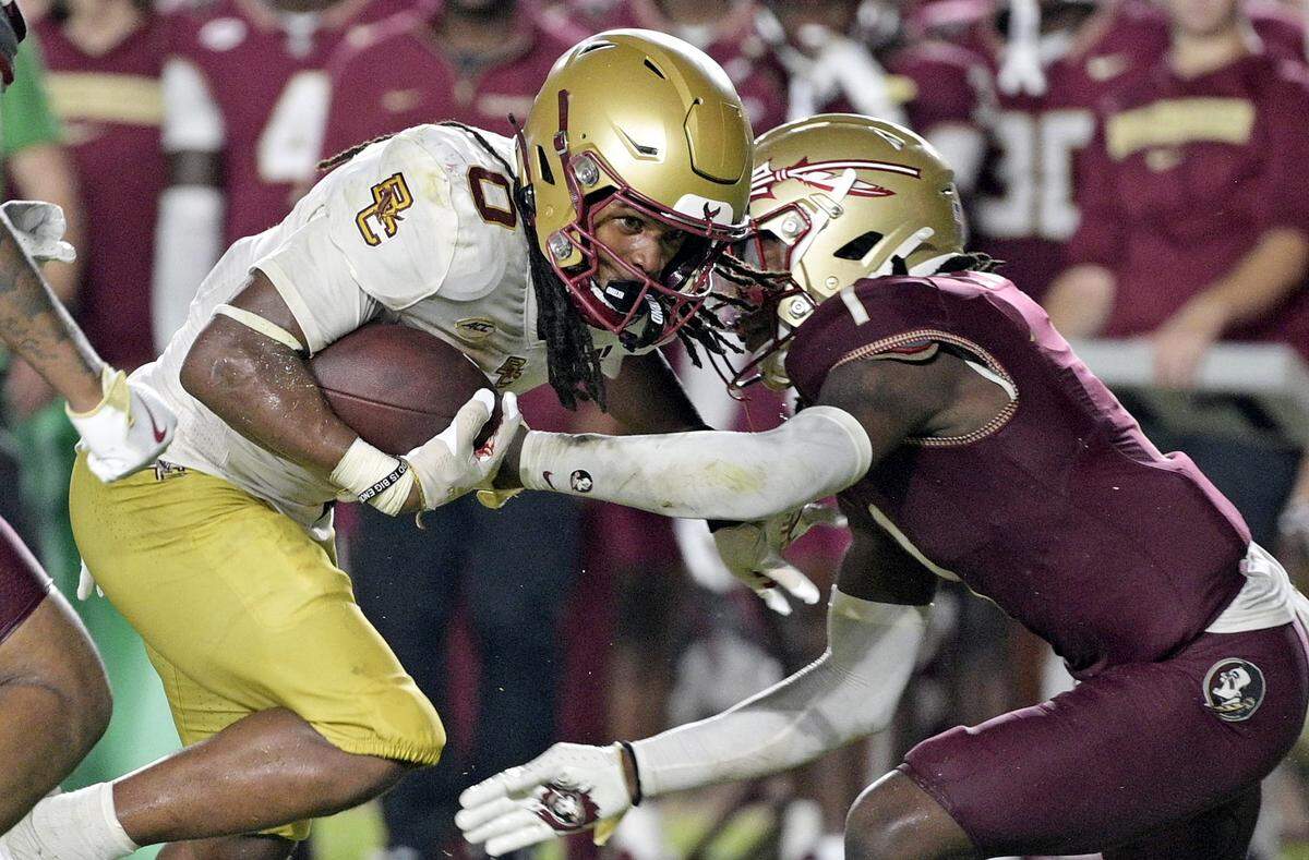 Boston College’s Treshaun Ward (0) runs the ball while Florida State’s Shyheim Brown (1) tries to tackle him during the Eagles’ 28-13 victory at Doak S. Campbell Stadium on Sept. 2, 2024.