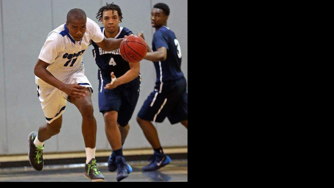 Clayton’s Gary Clark (11) heads down court after one of his defensive rebounds and Durham Hillside’s Malik Evans (4) can only watch during the first round of last year’s state 4A playoffs.
