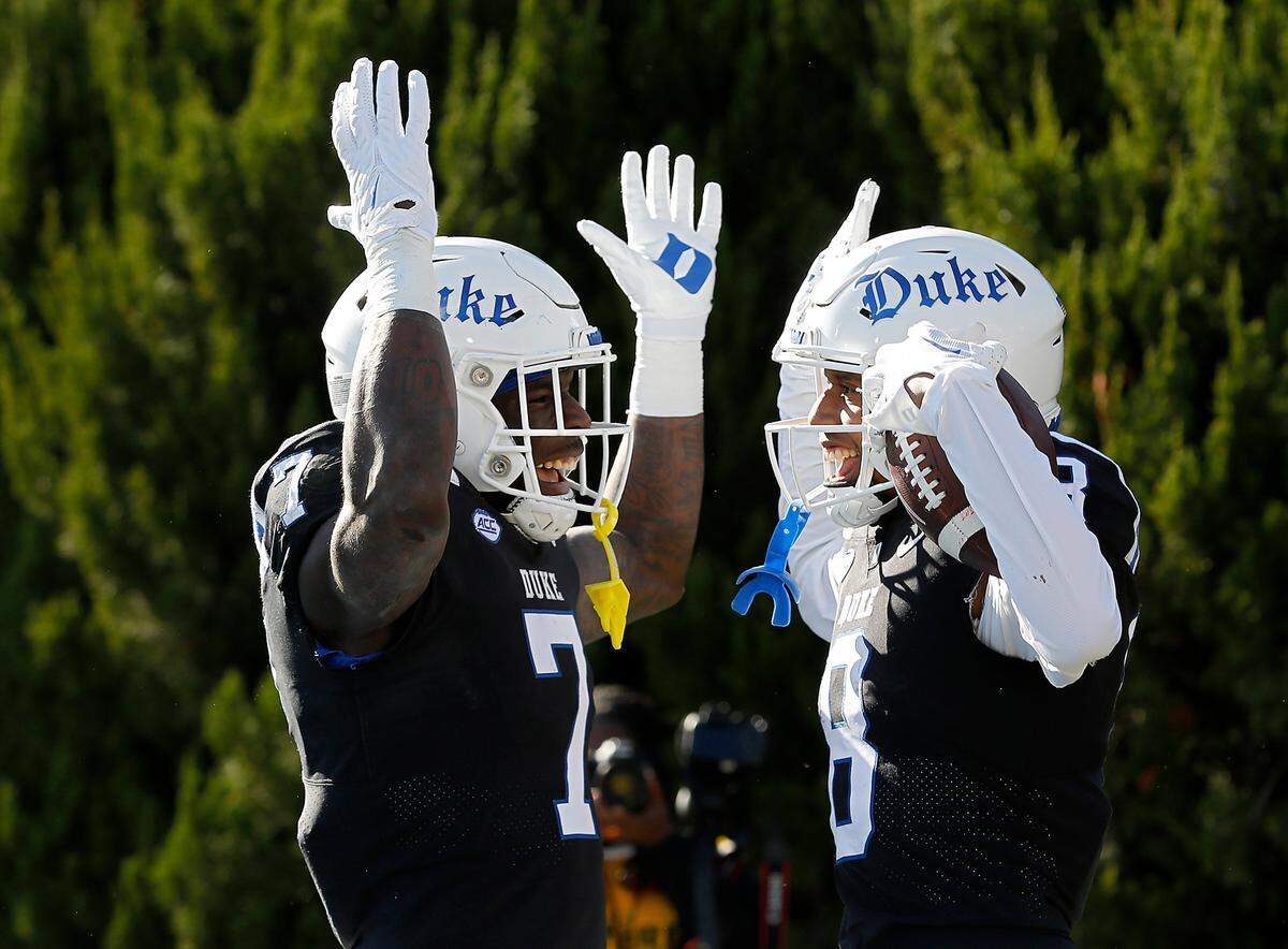Duke’s Jordan Moore, left, celebrates with teammate Jordan Waters after he scored a touchdown during the first half of the Blue Devils’ game against Pittsburgh on Saturday, Nov. 25, 2023, at Wallace Wade Stadium in Durham, N.C.