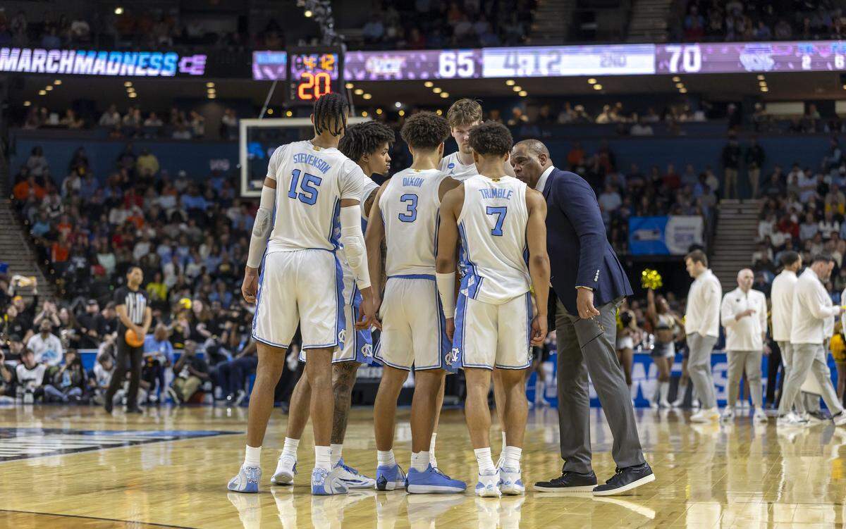 North Carolina coach Hubert Davis huddles with his players after VCU cut the Tar Heels’ 19 point lead to five, late in the second half on Thursday, March 18, 2026, during the first round of the NCAA Tournament at Bon Secours Arena in Greenville, S.C.