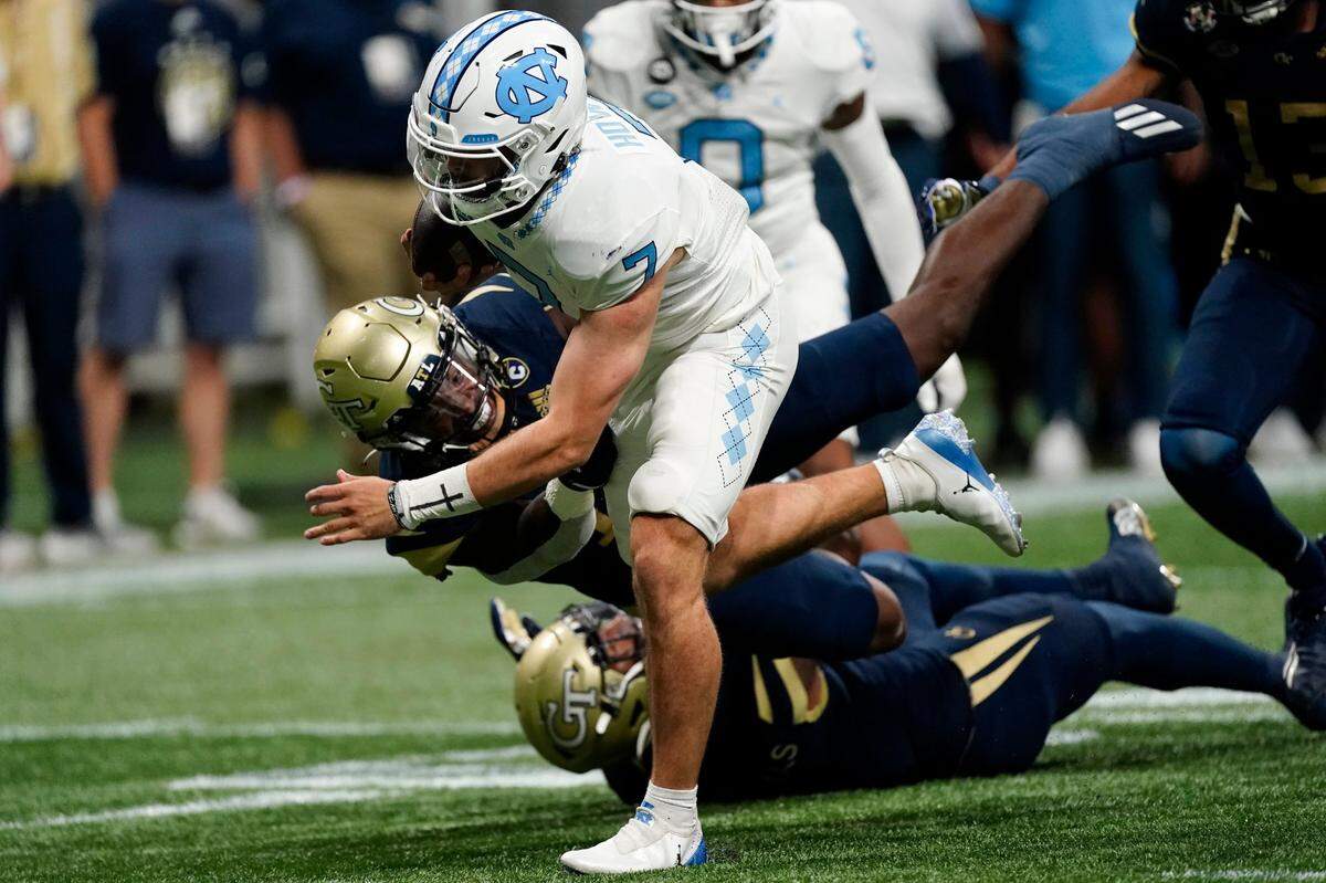 North Carolina quarterback Sam Howell (7) gets past Georgia Tech linebacker Ayinde Eley (10) to score a touchdown during the first half of an NCAA college football game Saturday, Sept. 25, 2021, in Atlanta. (AP Photo/John Bazemore)