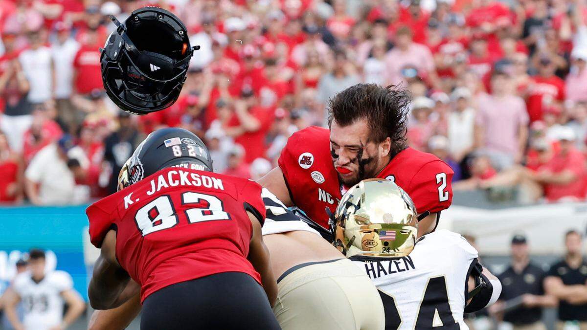 N.C. State quarterback Grayson McCall (2) helmet goes flying after being hit during the first half of N.C. State’s game against Wake Forest at Carter-Finley Stadium in Raleigh, N.C., Saturday, Oct. 5, 2024. McCall was injured on the play.