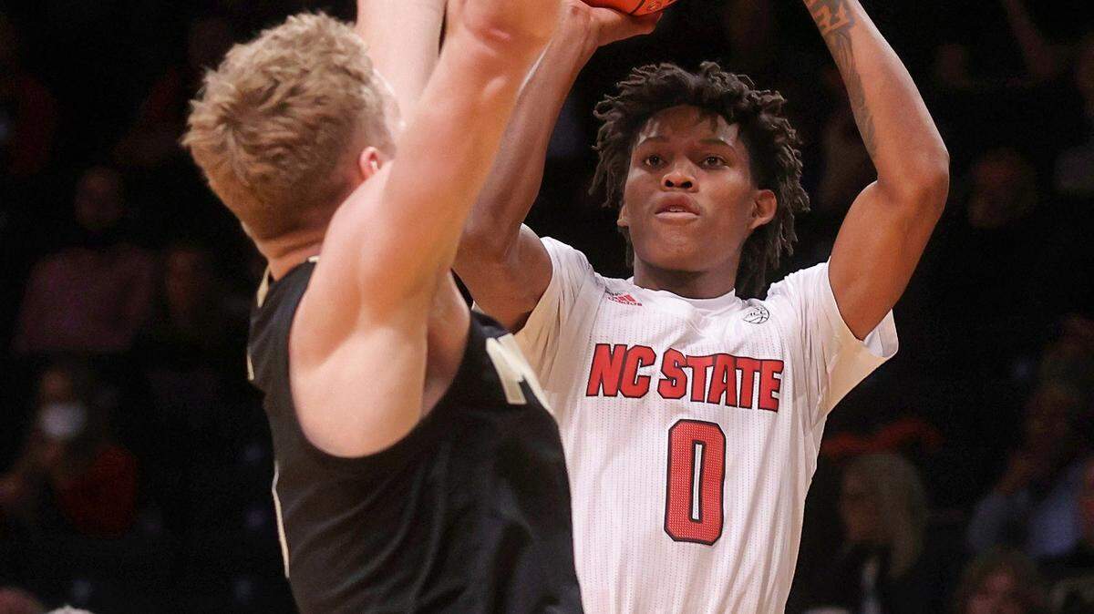 North Carolina State’s Terquavion Smith (0) shoots against Purdue’s Caleb Furst during the first half of an NCAA college basketball game Sunday, Dec. 12, 2021, in New York. (AP Photo/Jason DeCrow)