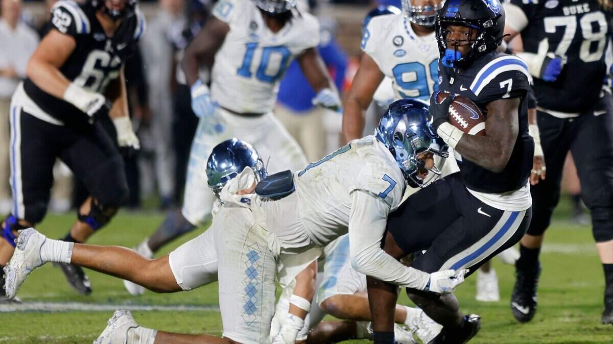 Duke Blue Devils running back Jordan Waters is tackled by North Carolina Tar Heels linebacker Noah Taylor during the second half of Saturday’s game at Wallace Wade Stadium in Durham, N.C.