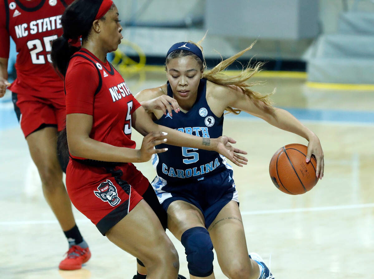 North Carolina’s Stephanie Watts (5) takes the ball around N.C. State’s Jada Boyd (5) during the second half of UNC’s 76-69 victory over N.C. State at Carmichael Arena in Chapel Hill, N.C., Sunday, February 7, 2021.
