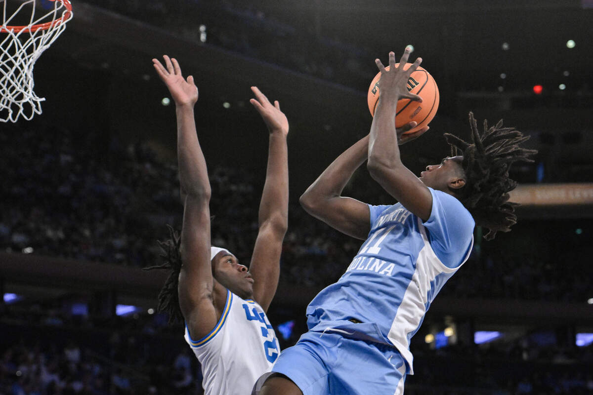 North Carolina Tar Heels guard Ian Jackson (11) shoots the ball while being defended by UCLA Bruins forward William Kyle III (24) during the second half at Madison Square Garden.