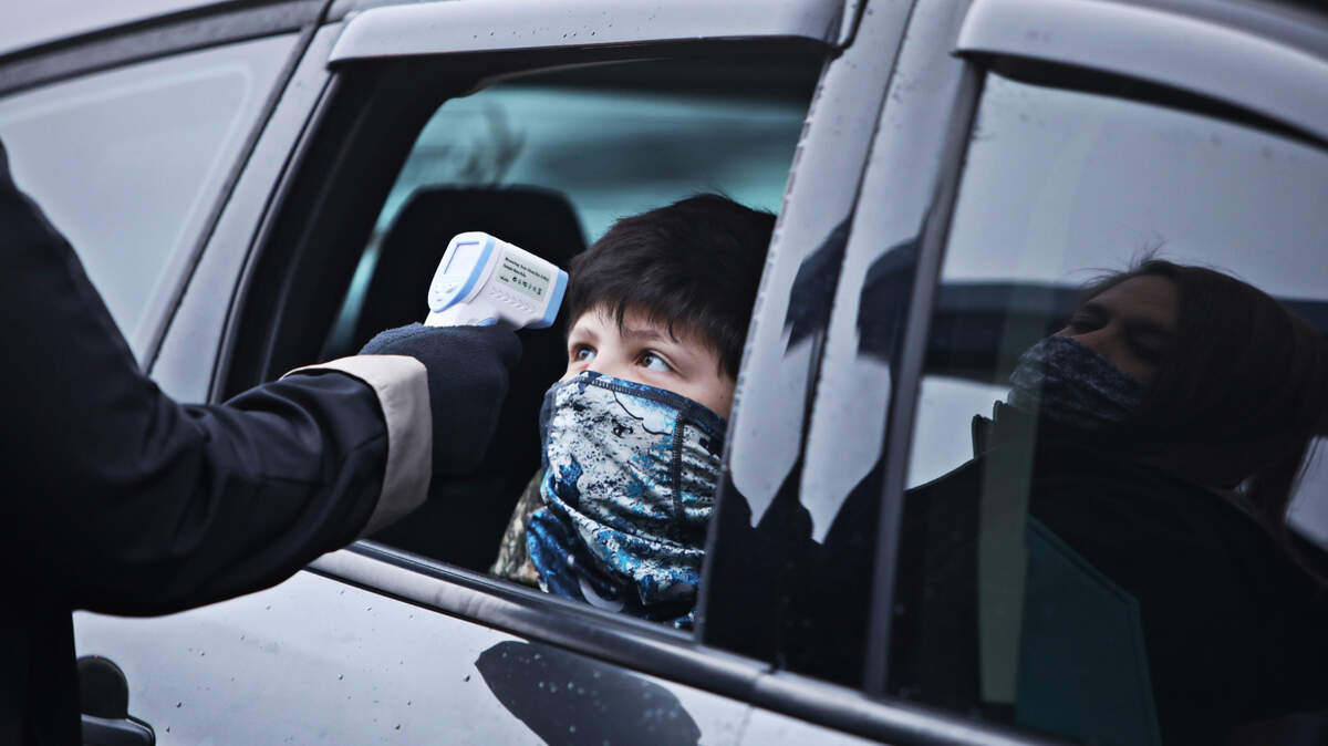 A student at Princeton Elementary School has his temperature checked in the drop-off lane Monday morning, Feb. 1, 2021, in Princeton, NC. Despite lobbying from some teachers to stay with remote instruction, Johnston students across all grade levels showed up Monday for their first day of in-person classes since Dec. 14.