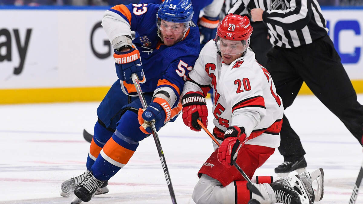 Apr 23, 2023; Elmont, New York, USA; New York Islanders center Casey Cizikas (53) and Carolina Hurricanes center Sebastian Aho (20) battle for a loose puck during the second period in game four of the first round of the 2023 Stanley Cup Playoffs at UBS Arena. Mandatory Credit: Dennis Schneidler-USA TODAY Sports