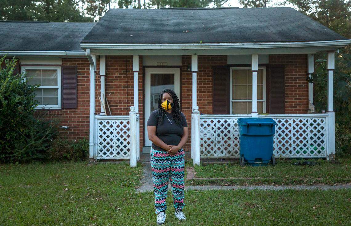 Ieisha Franceis stands for a portrait in her front yard while on strike and self-quarantining, though initially testing negative, after coming in contact with COVID-19 while working at Freddy’s Frozen Custard & Steakburgers last week, on Monday, Oct. 19, 2020, in Durham, N.C.
