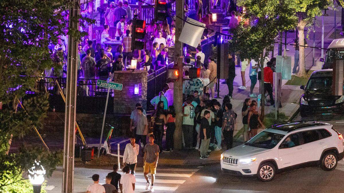 Glenwood Avenue and Cornerstone Tavern bustle with club-goers before 1 a.m. in the Glenwood South district on Friday, July 21, 2023.