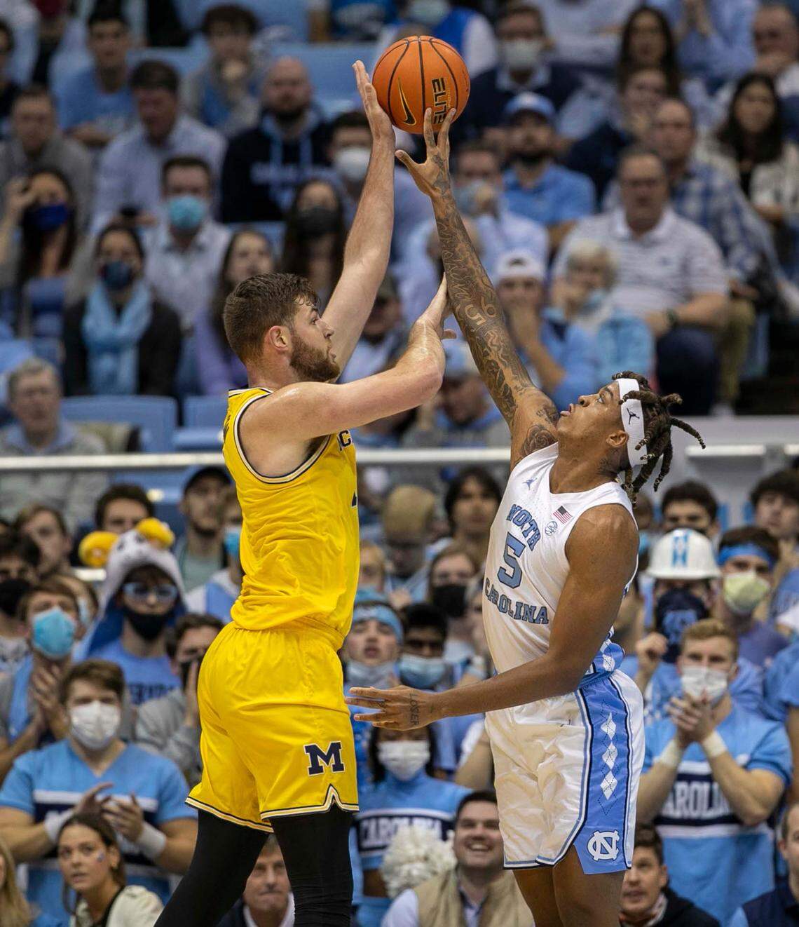 North Carolina’s Armando Bacot (5) defends Michigan’s Hunter Dickinson (1) during the first half on Wednesday, December 1, 2021 at the Smith Center in Chapel Hill, N.C.