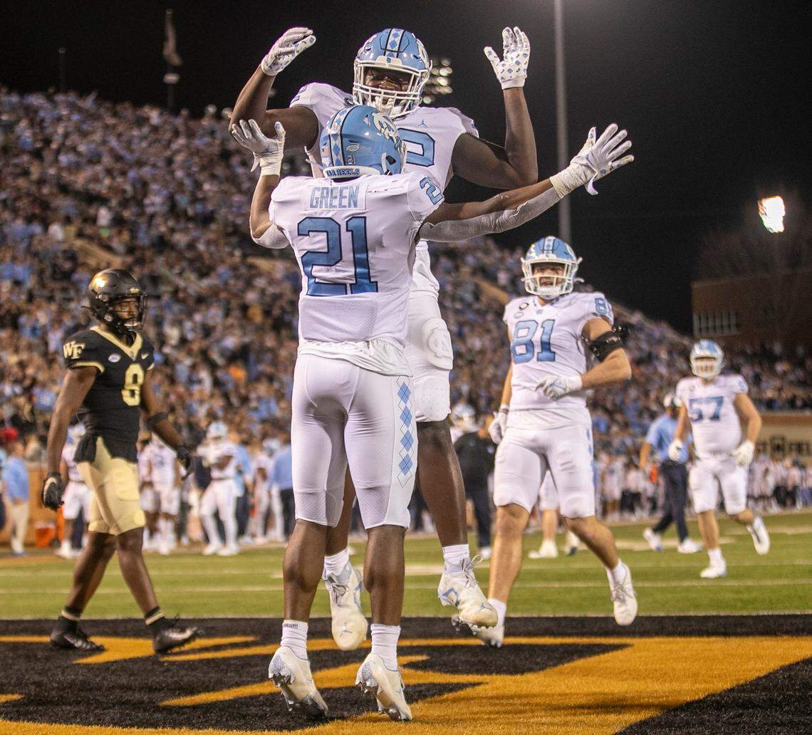 North Carolina’s Elijah Green (21) celebrates with teammate Asim Richards (72) after scoring a touchdown in the first quarter against Wake Forest on Saturday, November 12, 2022 at Truist Field in Winston-Salem, N.C.