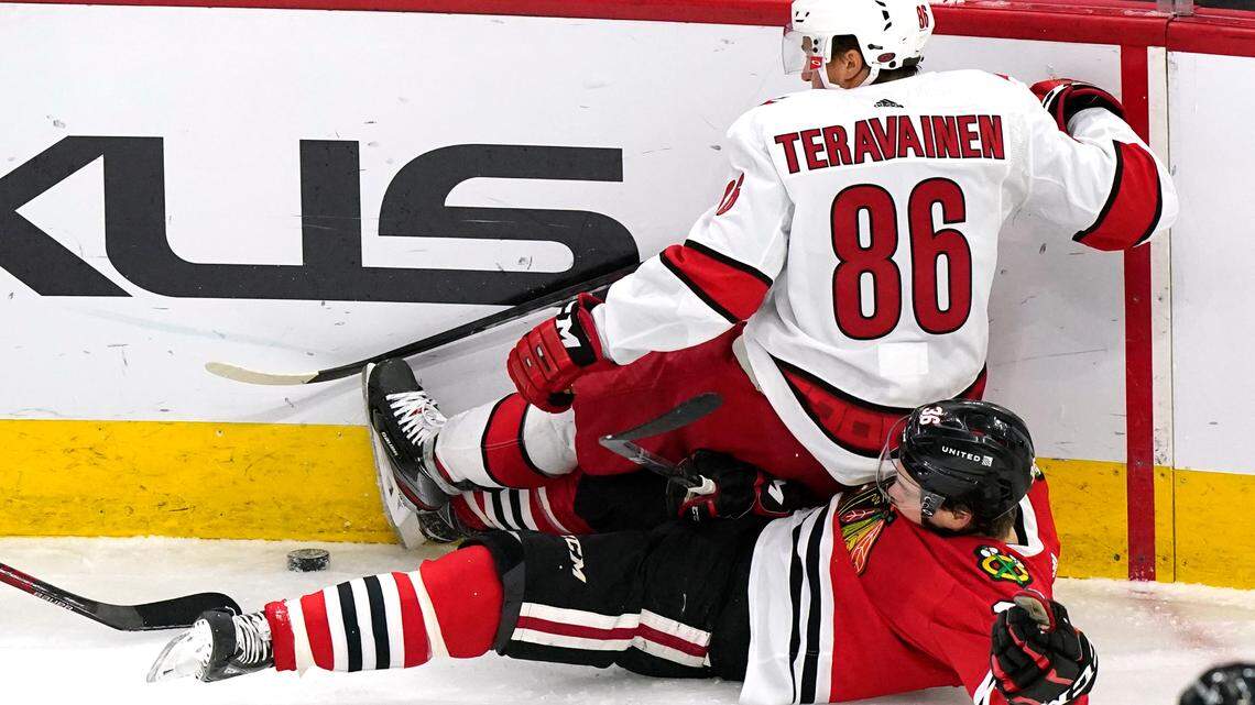Carolina Hurricanes left wing Teuvo Teravainen, top, vies for the puck against Chicago Blackhawks center Matthew Highmore during the first period of an NHL hockey game in Chicago, Thursday, Feb. 4, 2021. (AP Photo/Nam Y. Huh)