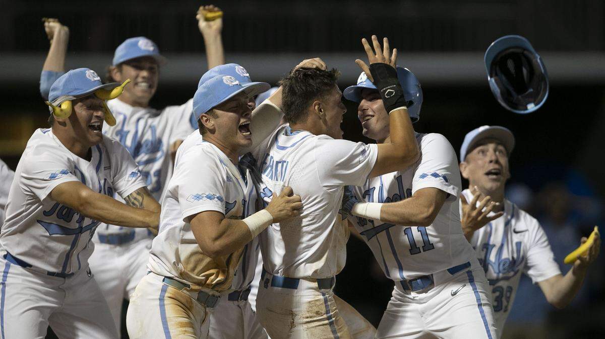 North Carolina second baseman Danny Serretti (1) is surrounded by his teammates as they celebrate their 7-6 victory over UNC-Wilmington during the NCAA Regional on Friday May 31, 2019 at Boshamer Stadium in Chapel Hill, N.C.