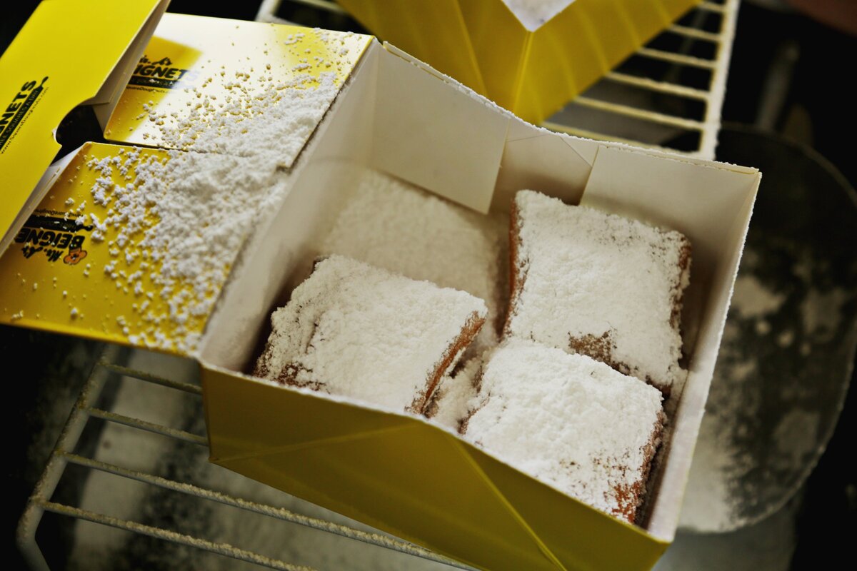 A fresh order of beignets is sugared before the box is closed and handed to a customer on Mr. A’s Beignet’s food truck on Thursday morning, Nov. 1, 2018, in Apex.