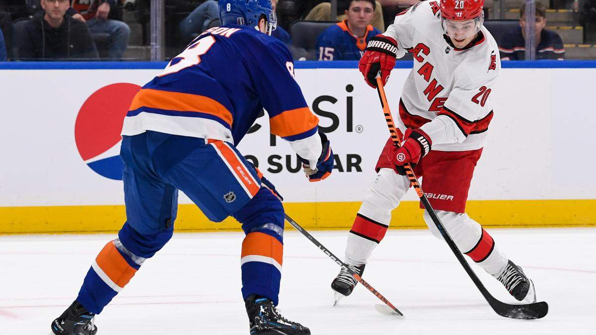 Carolina Hurricanes center Sebastian Aho (20) attempts a shot defended by New York Islanders defenseman Noah Dobson (8) during the first period in game three of the first round of the 2023 Stanley Cup Playoffs at UBS Arena.