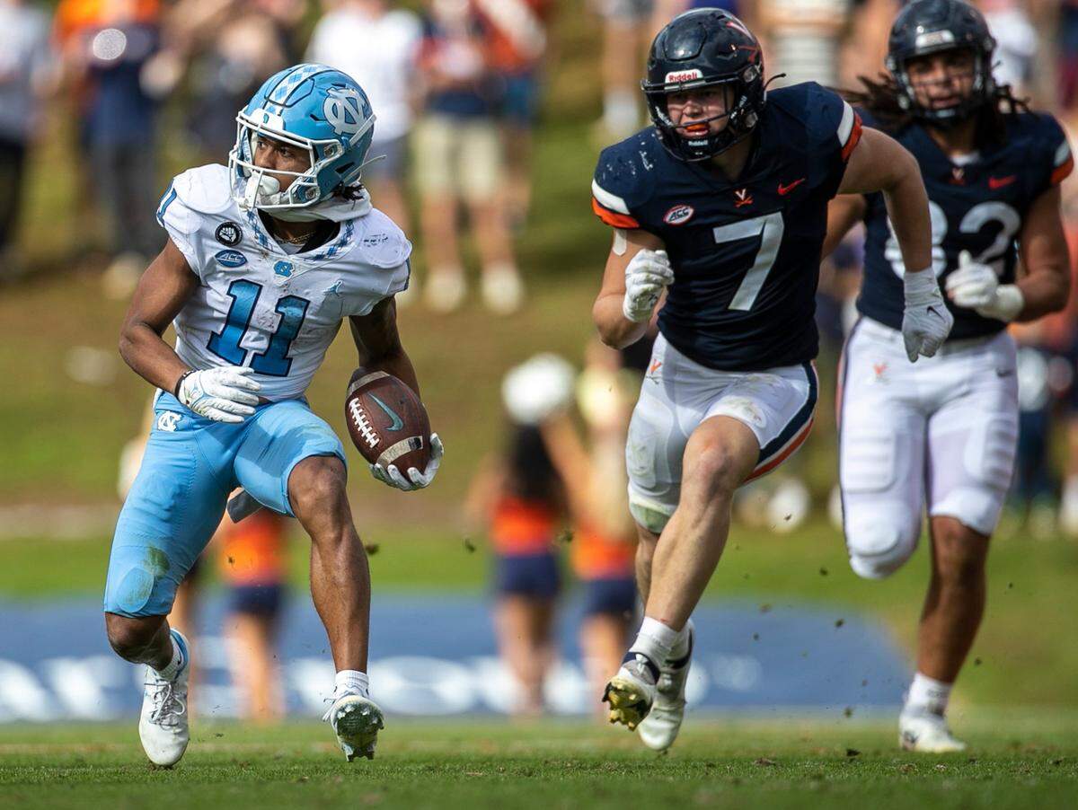 North Carolina’s Josh Downs (11) looks for running room after a 15-yard pass reception from quarterback Drake Maye in the third quarter on Saturday, November 5, 2022 at Scott Stadium in Charlottesville, Va.