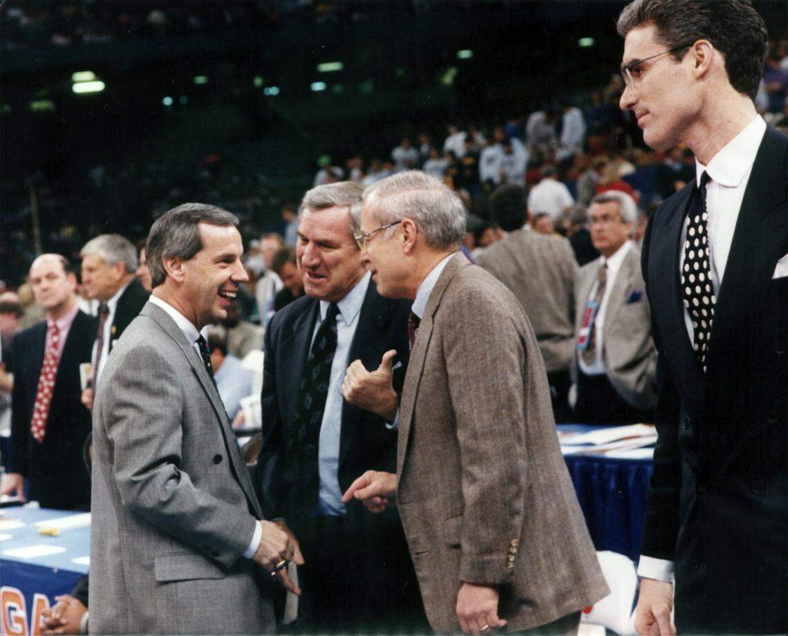 Roy Williams, Dean Smith, Bill Guthridge talk as Matt Doherty observes before UNC beat Kansas in the 1993 final four basketball tournament in New Orleans. Williams then coached Kansas and Doherty was his assistant.
