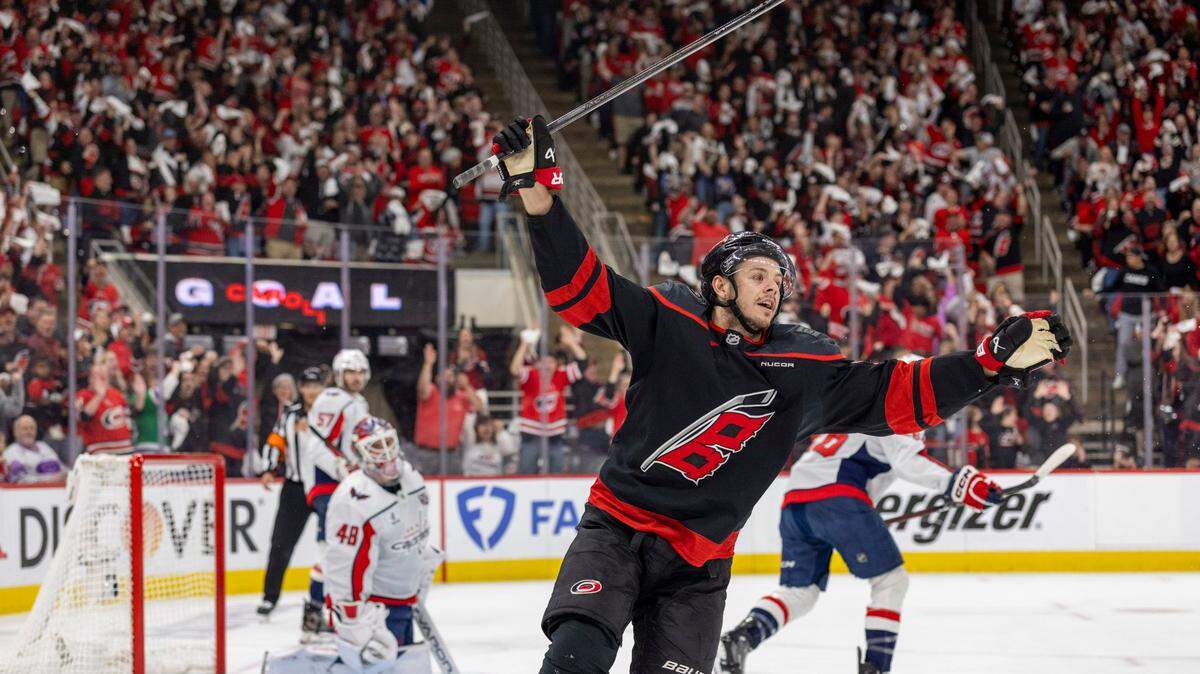 Carolina Hurricanes center Jesperi Kotkaniemi (82) reacts after a goal by teammate Shaye Gostisbehere (04) in the first period, to take a 1-0 lead against the Washington Capitals during Game 4 of their series on Monday, May 12, 2025 at Lenovo Center in Raleigh, N.C.