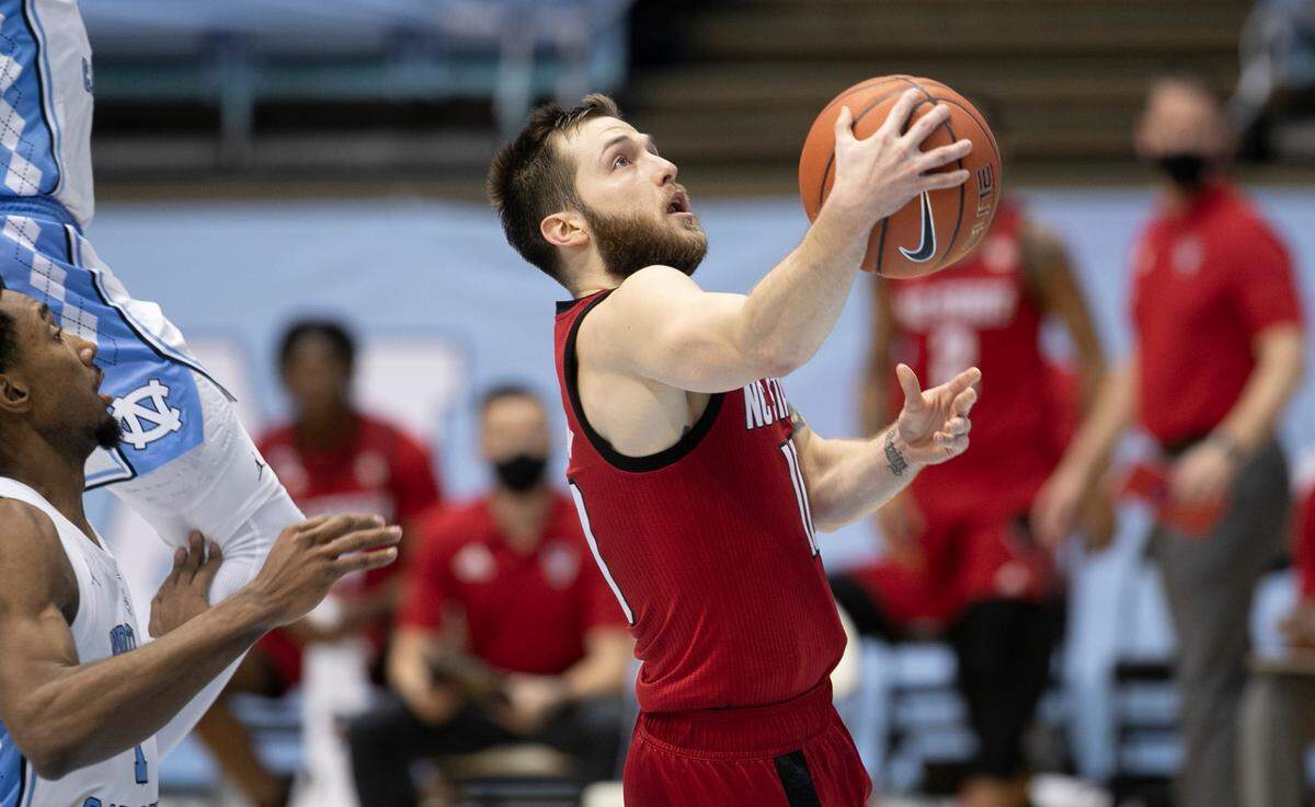 N.C. State’s Braxton Beverly (10) breaks to the basket past North Carolina’s Leaky Black (1) in the second half on Saturday, January 23, 2021 at the Smith Center in Chapel Hill, NC.