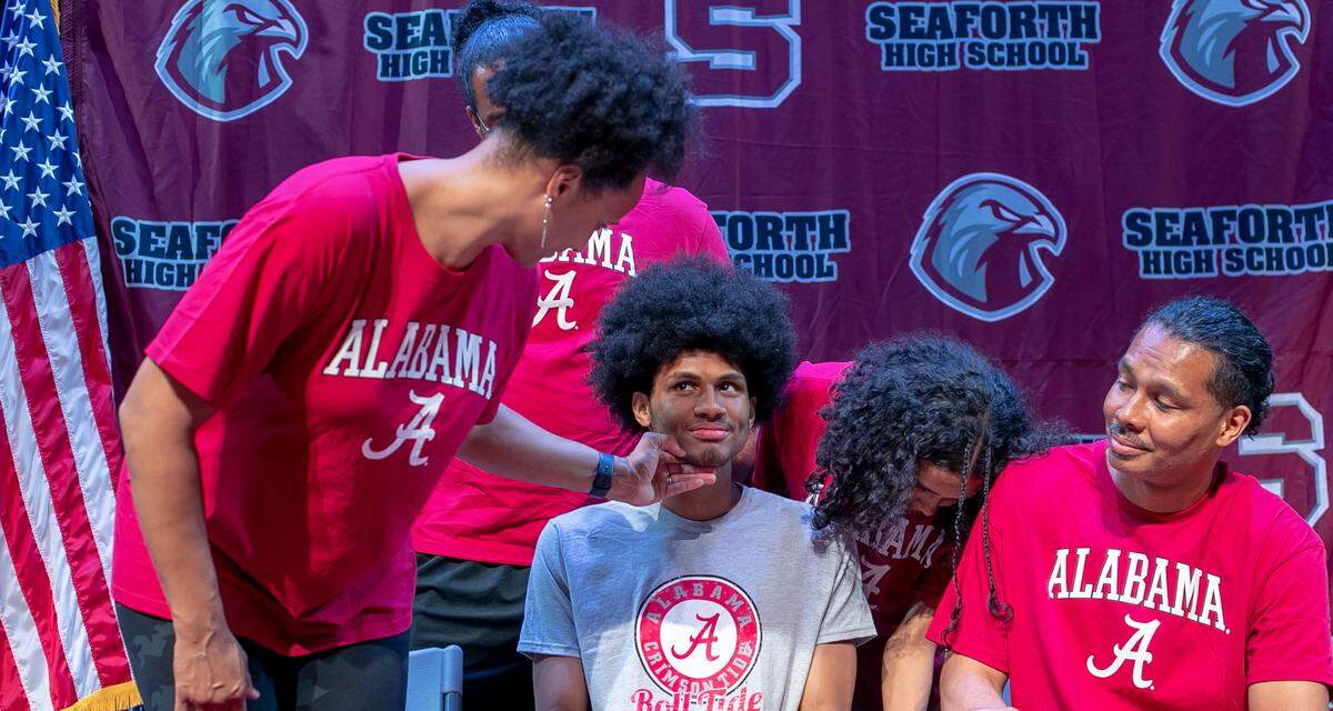 Nicole Stevenson checks her son Jarin’s face before a photo shoot at Seaforth High School on Tuesday June 27, 2023 in Pittsboro, N.C. It was Jarin Stevenson’s last visit to his high school. He would depart for the University of Alabama the next morning