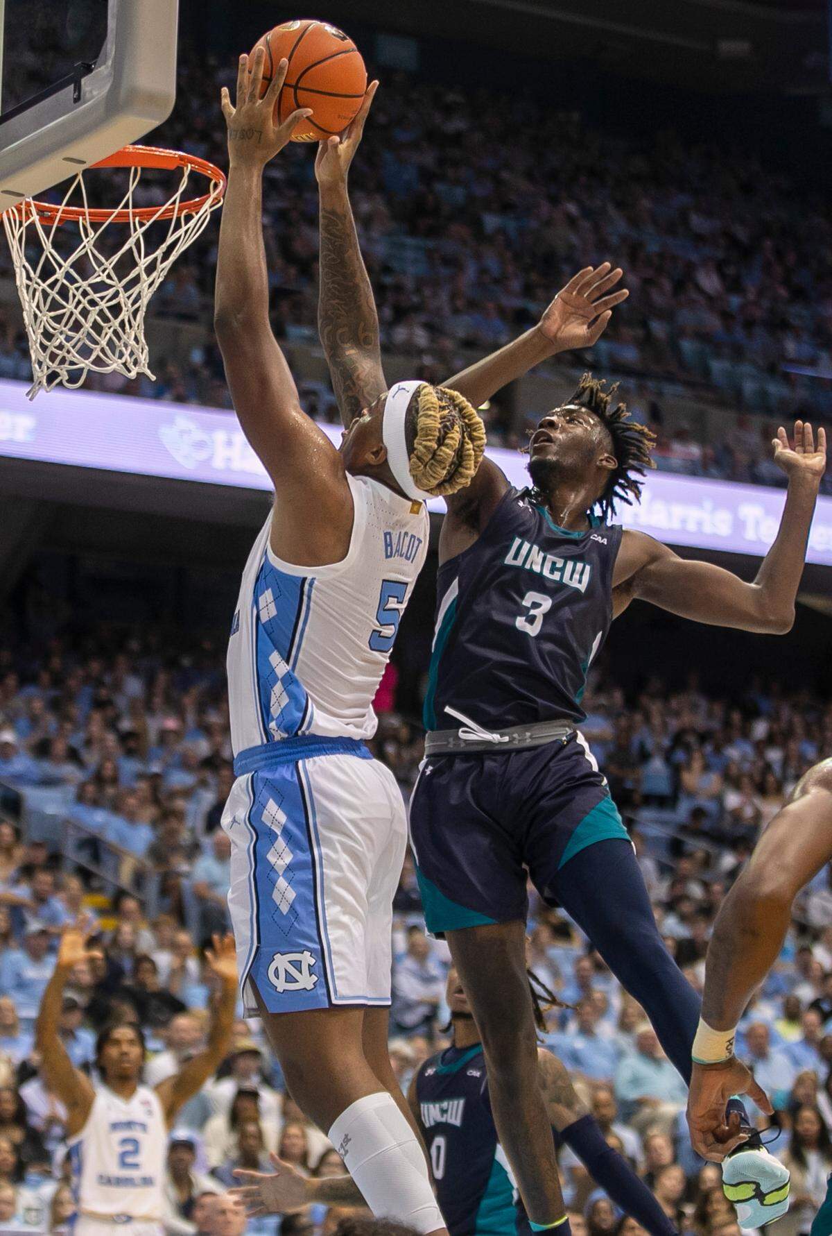 North Carolina’s Armando Bacot (5) drives to the basket against UNC Wilmington’s Maleeck Harden-Hayes (3) in the second half on Monday, November 7, 2022 at the Smith Center in Chapel Hill, N.C.