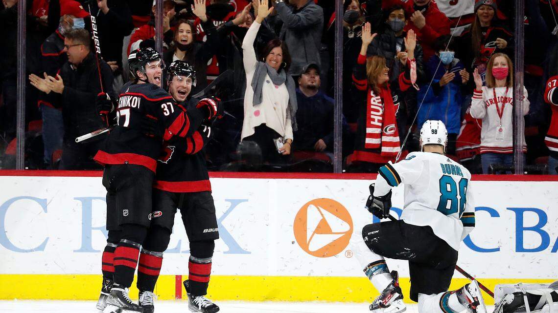 Carolina Hurricanes’ Andrei Svechnikov (37) is congratulated on his goal by teammate Jesper Fast (71) as San Jose Sharks’ Brent Burns (88) remains on the ice nearby during the third period of an NHL hockey game in Raleigh, N.C., Sunday, Jan. 30, 2022. (AP Photo/Karl B DeBlaker)