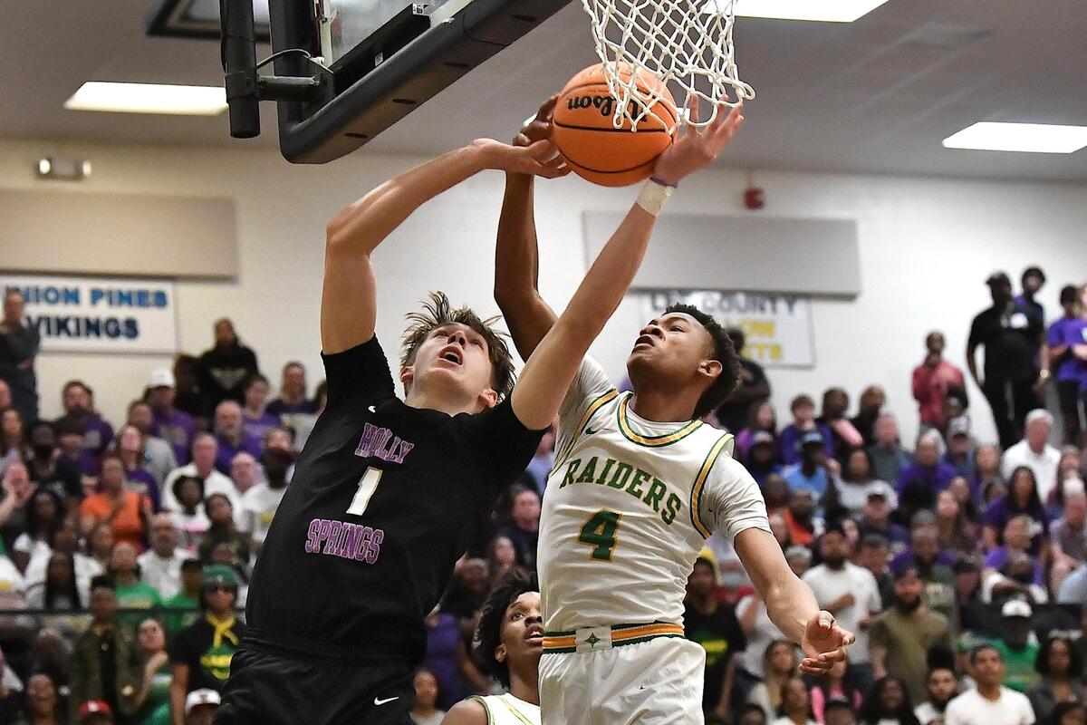 Richmond’s Zion Baldwin (4) blocks the shot from Holly Springs’ Collin Kuhl (1) during the first half. The Richmond Raiders and the Holly Springs Golden Hawks met in the NCHSAA 4A East Regional Finals in Sanford, N.C. on March 4, 2023.