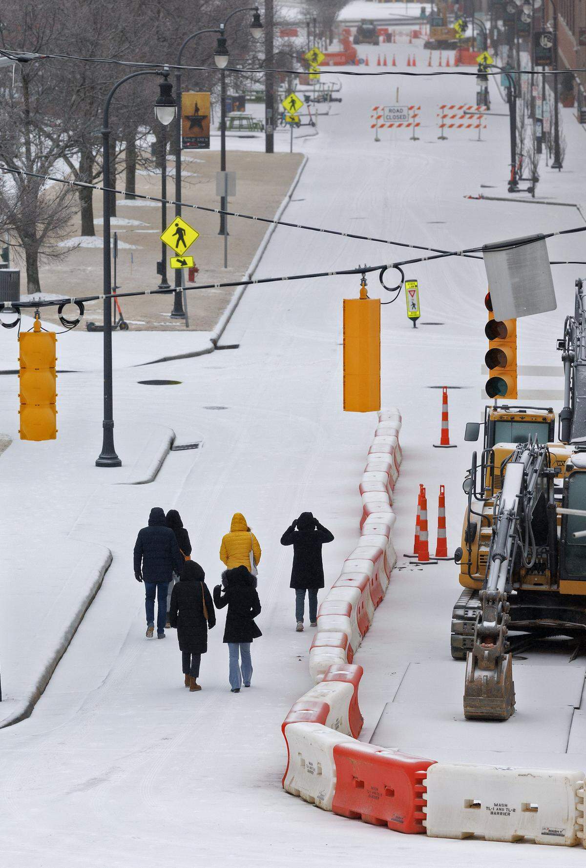 People walk down Blackwell Street as freezing rain falls in downtown Durham on Sunday, January 25, 2026.