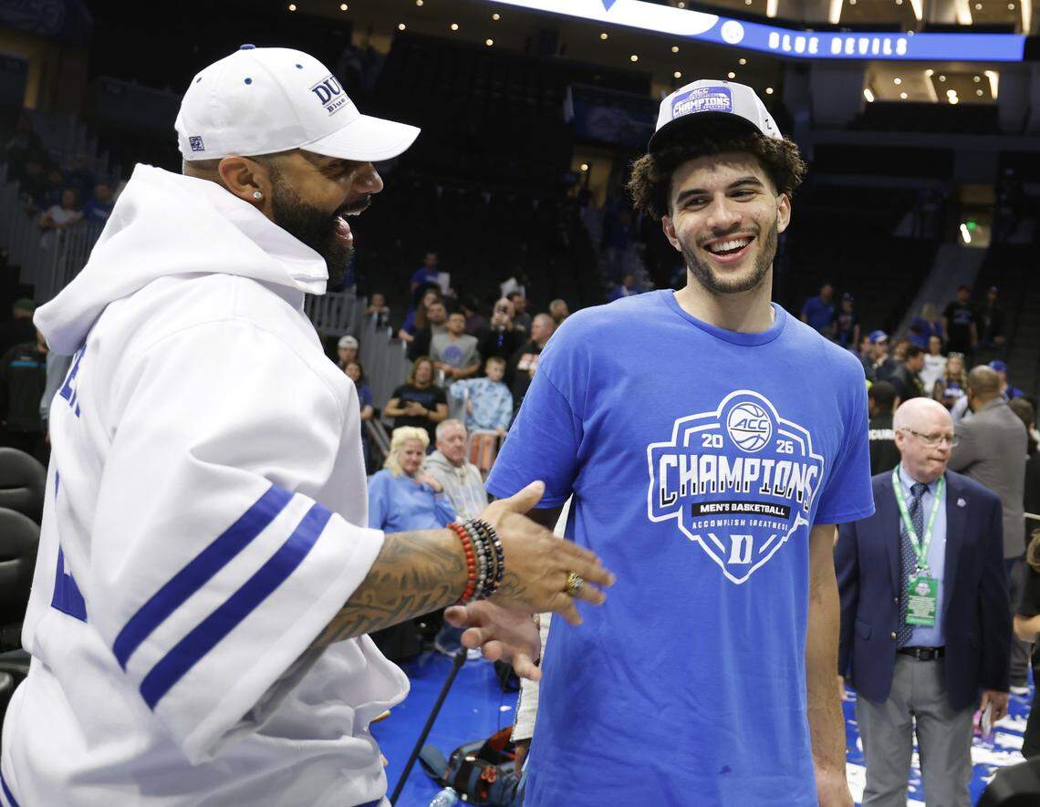 Carlos Boozer congratulates his son Cameron Boozer after Duke’s 74-70 victory over Virginia in the finals of the 2026 ACC Men’s Basketball Tournament at the Spectrum Center in Charlotte, N.C., Saturday, March 14, 2026.