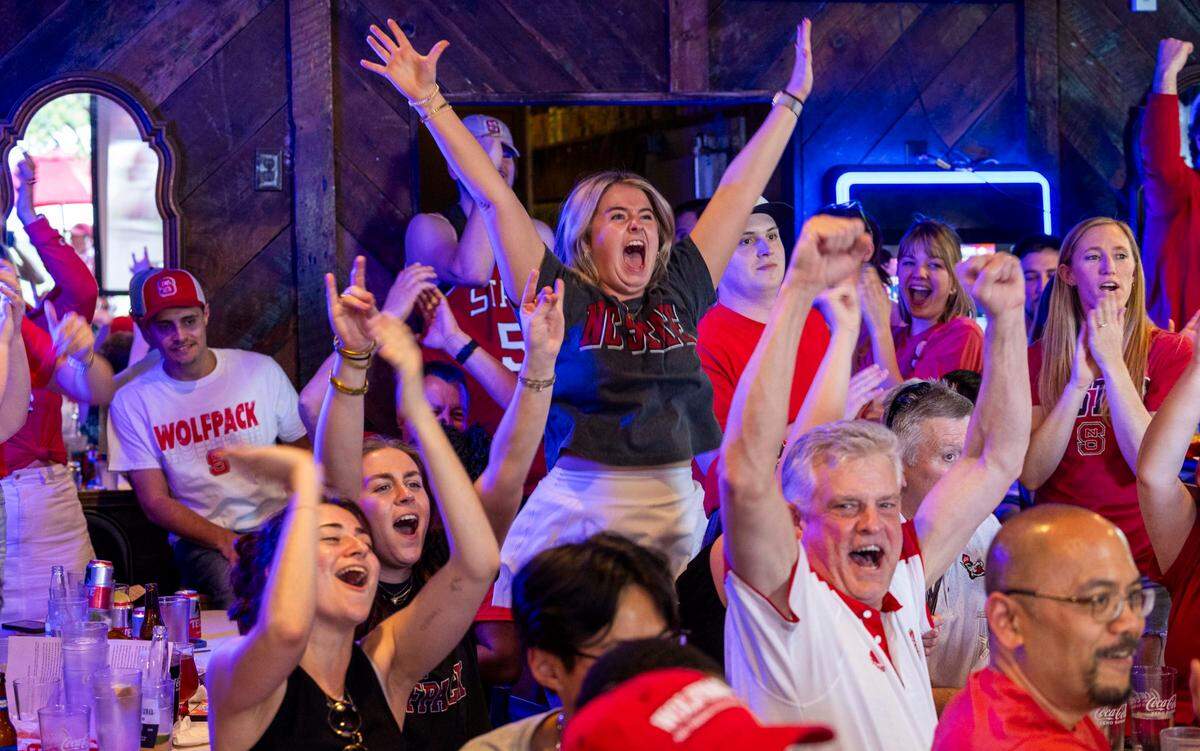 NC state fans at Players’ Retreat in Raleigh celebrate a Wolfpack lead against Duke during the second half of the Elite Eight round of the NCAA Men’s Division I Basketball Tournament on Sunday, March 31, 2024.