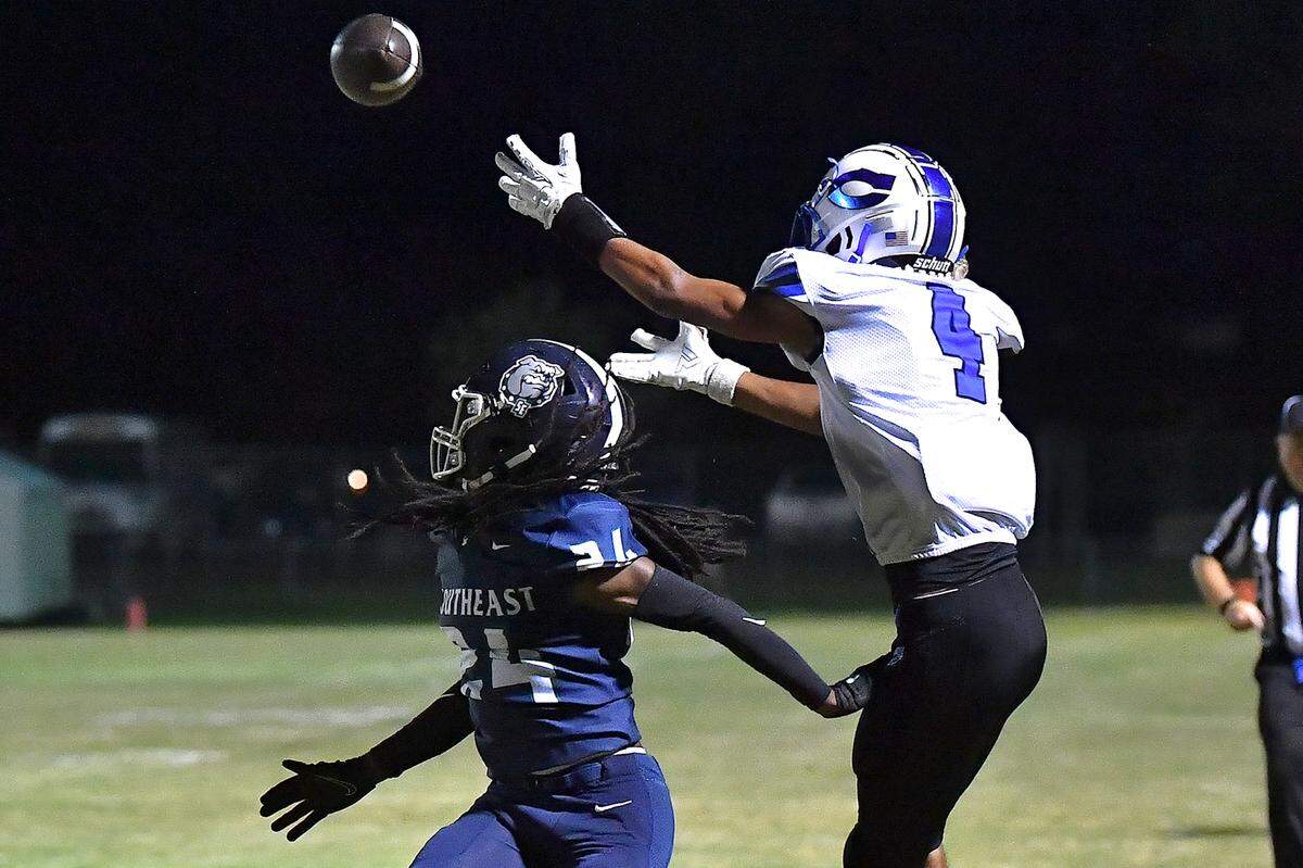 Clayton wide receiver TJ Campbell (4) attempts the catch near the end zone over Southeast Raleigh defensive back Mike Rowland (24) during the first half. The Southeast Raleigh Bulldogs and the Clayton Comets met in a non-conference football game in Raleigh, N.C. October 3, 2025