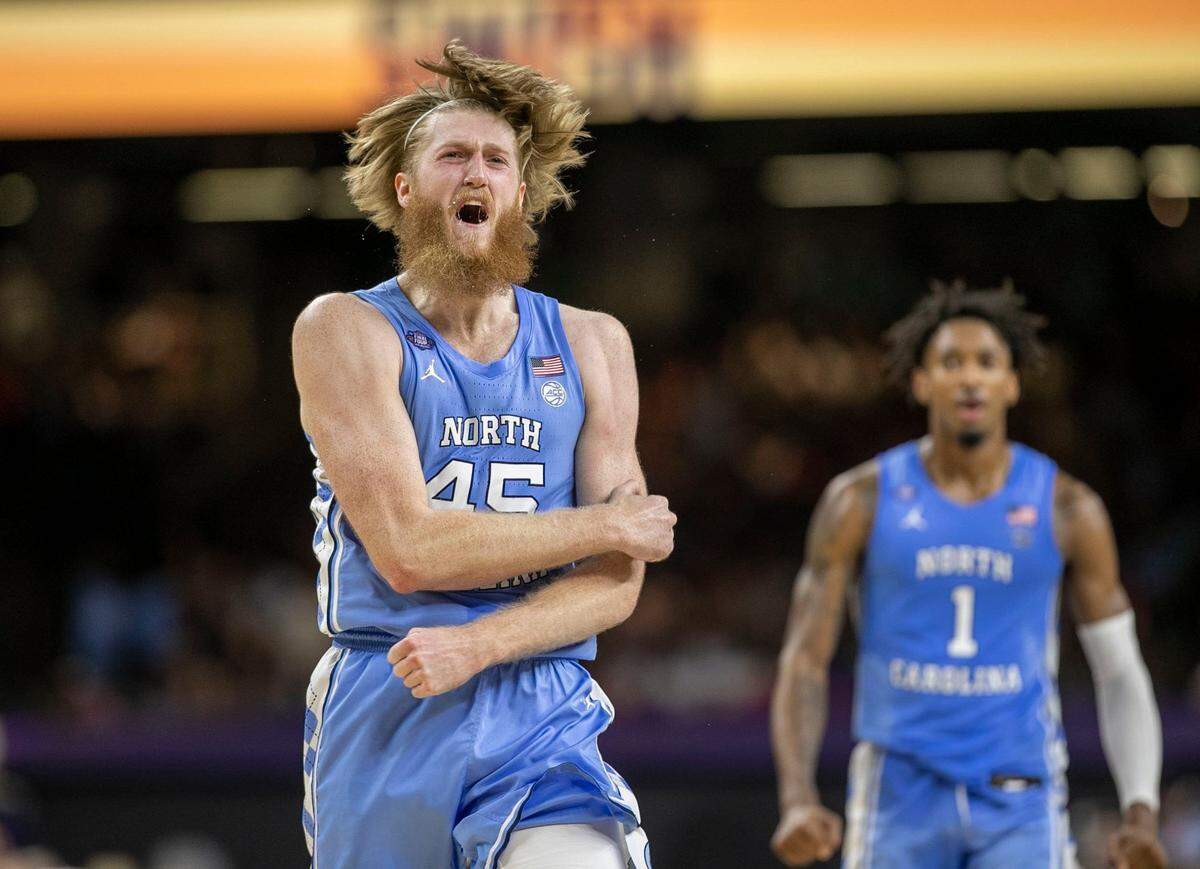 North Carolina’s Brady Manek (45) and Leaky Black (1) react after a three-point basket by Manek to give the Tar Heels a 28-22 lead over Kansas during the first half of the NCAA Championship game on Monday, April 4, 2022 at Caesars Superdome in New Orleans, La.