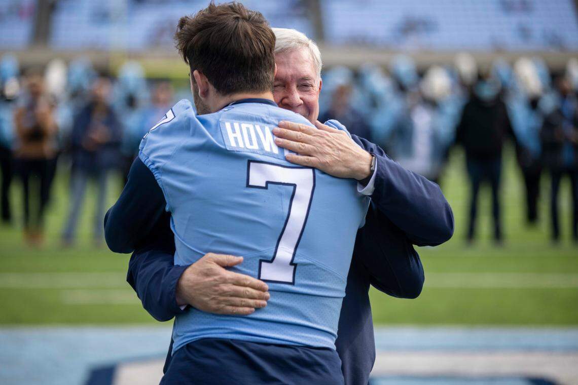 North Carolina coach Mack Brown embraces Sam Howell during Senior Day recognition prior to the Tar Heels’ game against Wofford on Saturday, November 20, 2021 at Kenan Stadium in Chapel Hill, N.C.