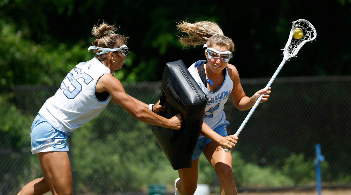 North Carolina’s Chloe Humphrey (2), right, runs a drill with Paige Kelly (25) during a practice at UNC on Friday, May 2, 2025.