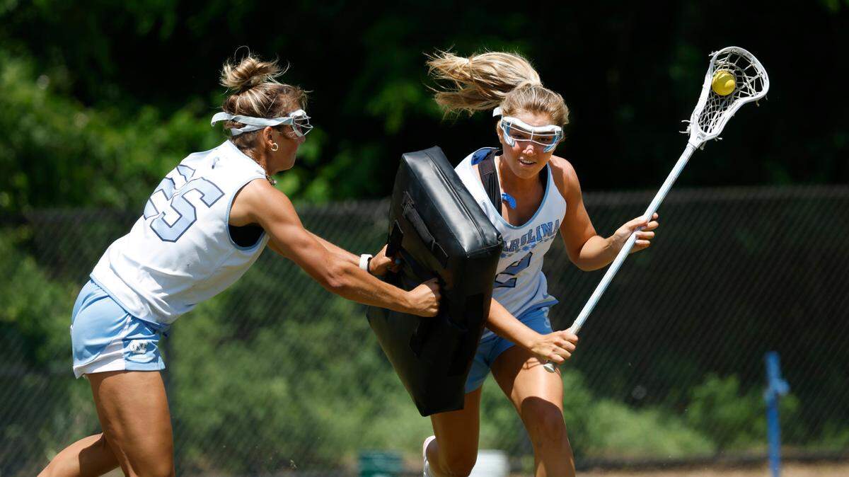 North Carolina’s Chloe Humphrey (2), right, runs a drill with Paige Kelly (25) during a practice at UNC on Friday, May 2, 2025.