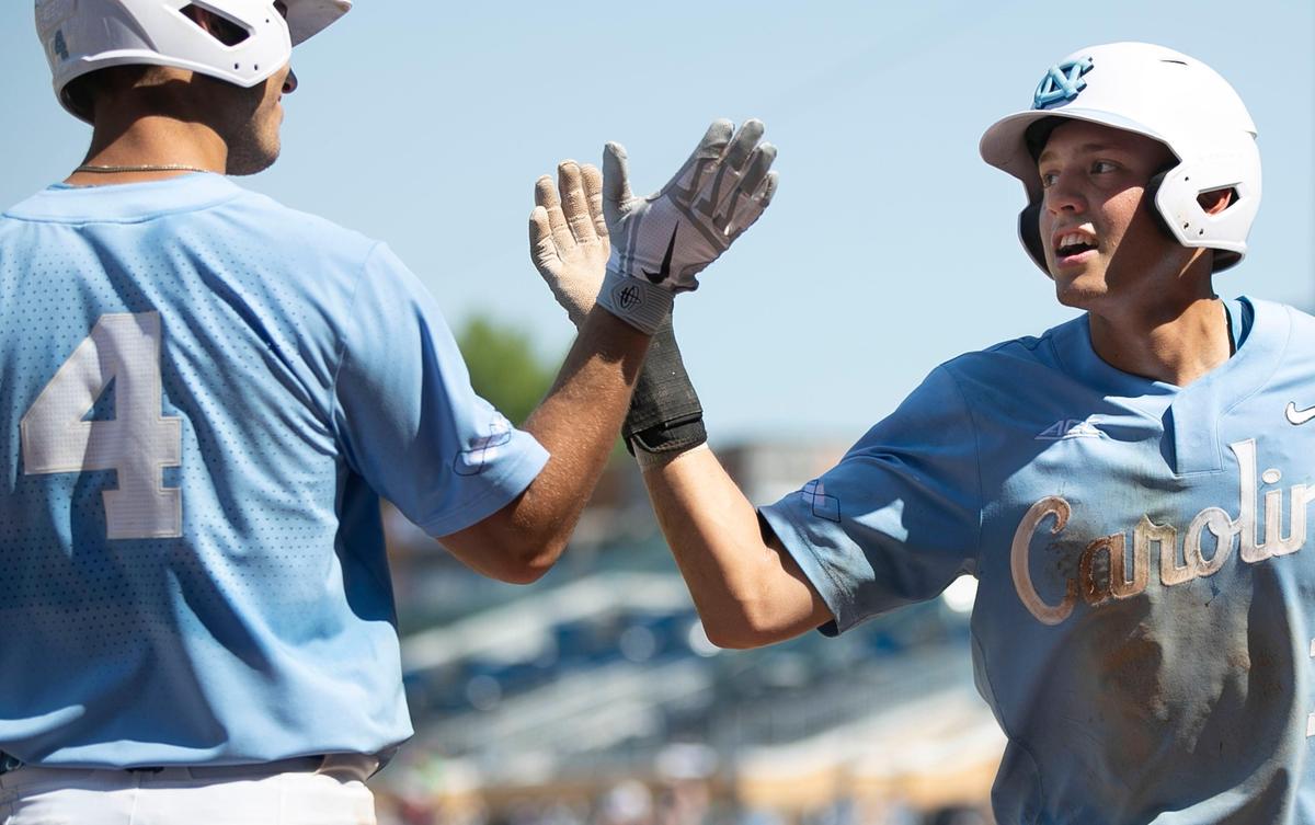 North Carolina’s Brandon Martorano (4) greets teammate Danny Serretti (1) after he scored on a single by Ike Freeman in the sixth inning to give the Tar Heels a 10-5 lead against Boston College in the semi-finals of the ACC Baseball Championship on Saturday, May 25 2019 at Durham Bulls Athletic Park in Durham, N.C.