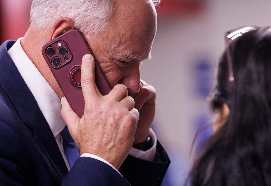Democratic Vice Presidential nominee and Minnesota Gov. Tim Walz makes a phone call during a visit to a campaign office to Raleigh, N.C. on Thursday, Aug. 29, 2024.