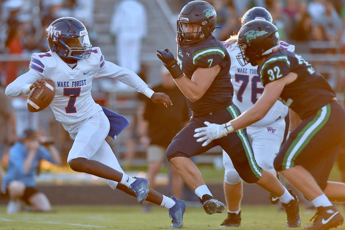 Leesville Road’s Braxton Lassiter (7) pressures Wake Forest quarterback Kavon Simmons (7) during the first half. The Wake Forest Cougars and the Leesville Road Pride met in a football game in Raleigh, N.C. on September 15, 2023.